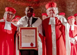 Il se présente comme un chrétien pratiquant qui fut enseigné par Maurice KAMTO à l'IRIC