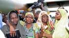 Freed hostages react as they arrive at the Nsimalen International Airport